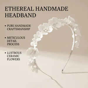 Close-up of handmade white ceramic flowers and bead details on a bridal headband