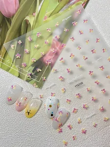 Detailed view of 3D pink petal nail stickers on soft gradient floral manicures