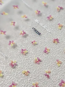 Macro shot of YT8358 floral nail art stickers featuring watercolor daisy and cherry blossom
