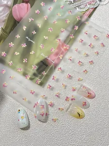 Detailed view of floral nail art stickers with pink and yellow flowers and tulip decor