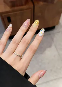 Detailed close-up of gold flower nail art stickers with embossed stars and floral motifs