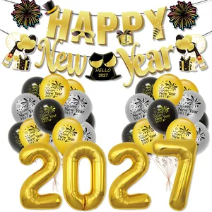 Detail of 2027 Happy New Year party set with gold foil balloons and banners