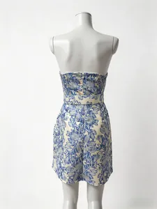 Rear view of a blue and white floral tube dress with waist belt and back zipper