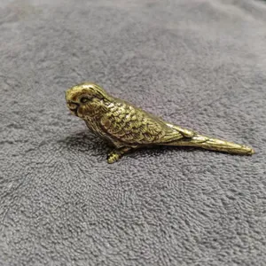 Macro detail of solid brass parrot figurine showing realistic feather textures