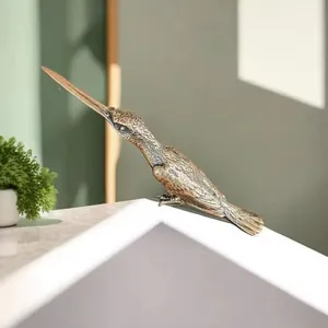 Detailed view of a solid brass kingfisher sculpture showing intricate feather texture