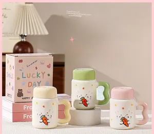Detailed view of colorful rabbit ceramic mugs with wavy handles and gift boxes