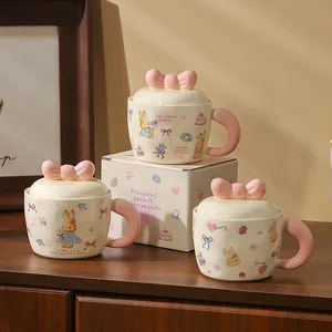 Detail of pink rabbit ceramic mugs with 3D bow handles and matching gift boxes