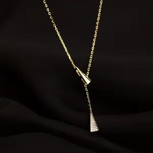 Lariat necklace in gold finish featuring a sliding polished triangle and crystal pavé