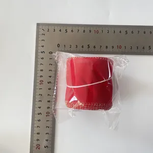 Detail view of 6cm red velvet Christmas ribbon with gold edges on measuring scale