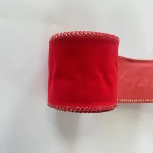 Close-up of red velvet Christmas ribbon with gold wired edges for gift wrapping