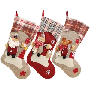 Three large Christmas stockings featuring 3D Santa, Snowman, and Reindeer in plaid patterns