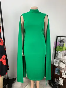 Detailed view of emerald green cape dress featuring high neck and bodycon fit