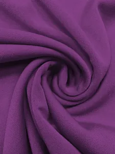 Detailed macro shot showing the dark purple textured mesh fabric of the cape dress