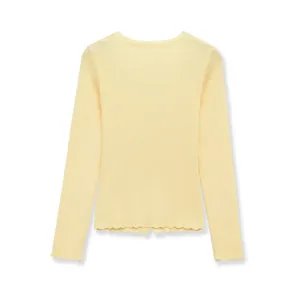 Rear view of a light yellow ribbed knit sweater featuring a stylish lettuce edge hem