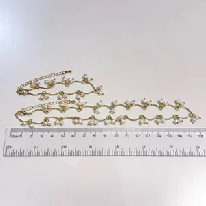 Elegant gold freshwater pearl fringe necklace and bracelet set shown with ruler