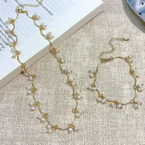 Elegant gold finish necklace and bracelet set with delicate white freshwater pearls