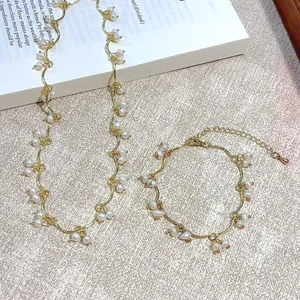 Elegant gold freshwater pearl necklace and bracelet set with grape-inspired tassels
