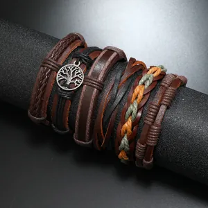 Close-up of vintage multi-layer leather bracelets with a Tree of Life metal charm