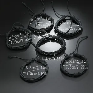 Detail of tree of life charm and adjustable braided leather bracelet set for men