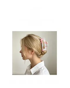 Side view of large hollow pink and white marble acrylic hair claw clip for women's hairstyle