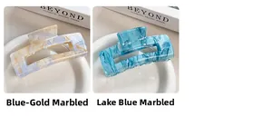 Detail of marbled rectangular hair claws in blue gold and lake blue artistic patterns