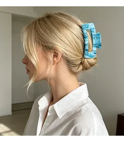 Blue marble hair claw clip in rectangular design styled on a blonde model's hair
