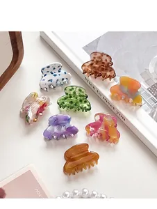 Detailed set of eight mini acetate hair claws in various elegant marble and floral patterns