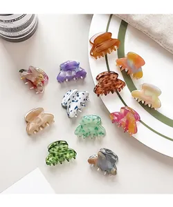 Close-up of small acetate hair claws in various marble colors and tortoiseshell patterns