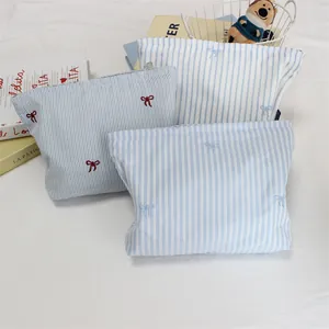 Three-piece striped cotton cosmetic bag set with embroidered bows and metal zippers