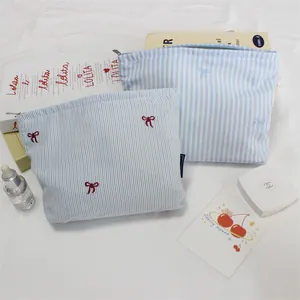 Blue striped canvas makeup bag set with bow embroidery and metal zipper closure