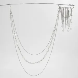 Detail of multi-layered pearl tassel chain with silver pins for suit decoration