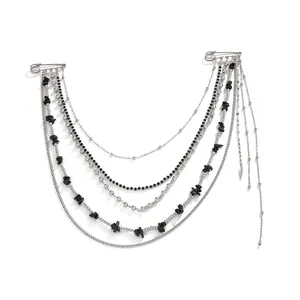 Close-up of gothic punk brooch with multi-layer silver chains and black beads