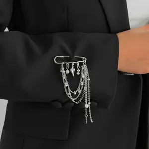 Silver safety pin brooch with multi-layer chains, heart pendant and pearls on black suit