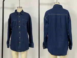 Detailed view of dark blue denim shirt featuring metal buttons and dual chest pockets