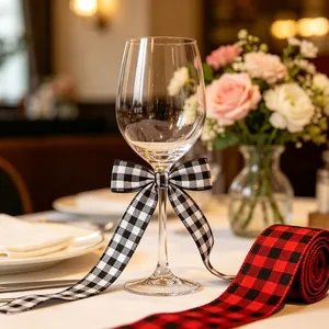 Close-up of red and black plaid wired ribbon tied on a glass for Christmas decor