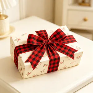Close-up of a festive red and black buffalo plaid ribbon bow on a floral gift box