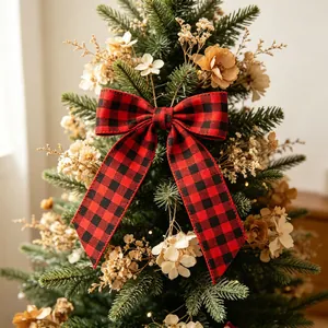 Close-up of red and black buffalo plaid Christmas ribbon bow on decorated tree