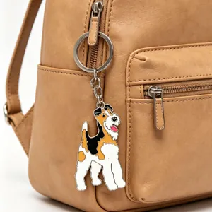 Cute enamel fox terrier dog keychain on a brown leather backpack with silver metal ring