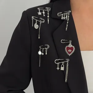 Detail of silver alloy star and heart charms on a black blazer lapel with chain