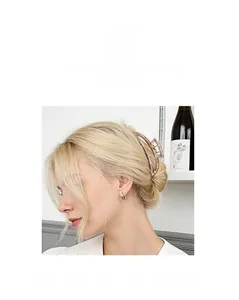 Detailed view of amber resin hair claw clip securing a bun on model with classic style