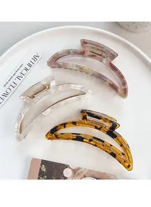 Three large crescent hair claws in marble, pearlescent white and tortoiseshell finishes