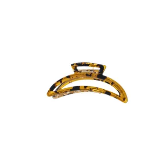 Elegant crescent moon amber patterned hair claw clip with metallic spring on white background