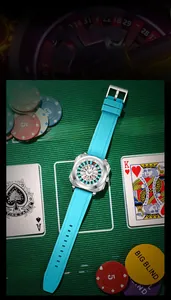 Detail of light blue silicone watch band with square silver buckle and roulette poker dial