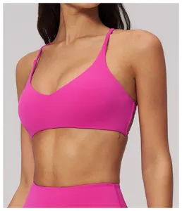 Dettaglio del reggiseno sportivo rosa intenso con schiena incrociata e scollo a V