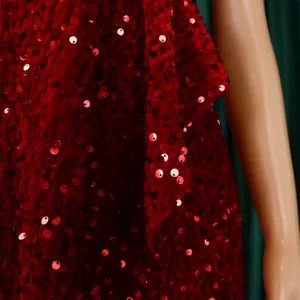Macro view of tight red sequins on velvet evening dress fabric with soft folds