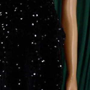 Close-up of black sequined evening dress fabric on mannequin with sparkling details