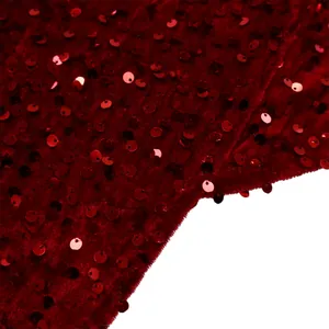 Detailed macro view of high-density red sequins on luxury velvet evening gown fabric