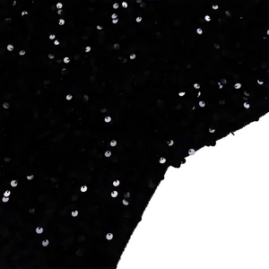 Detailed macro view of black sequined evening gown fabric with silver reflections