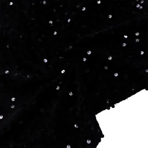 Macro view of black sequin fabric with metallic silver reflections on luxury evening dress
