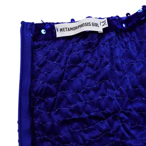 Detailed view of royal blue sequined fabric with pleated texture and M size label